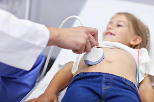 Doctor testing young girl with usg stock photo
