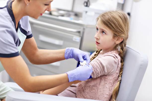 istock Brave little girl having blood collection for tests 1051318684