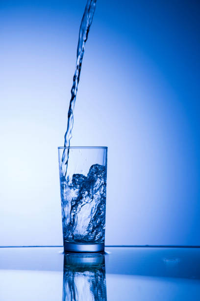 istock Water pouring from jug into glass 1051319720