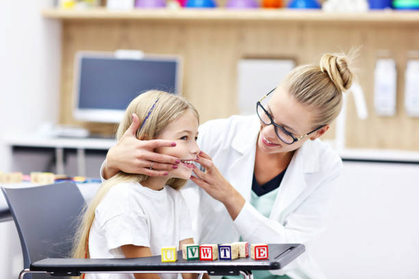 istock Cute little girl at speech therapist office 1051319752