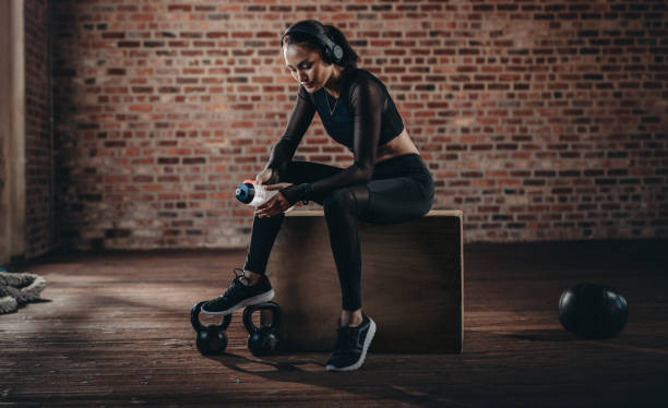 istock Woman relaxing after workout at gym 1051319956