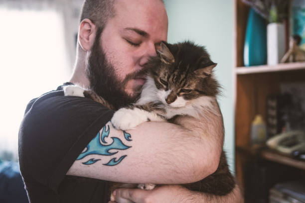 Portrait of a white bearded man with shaved head embracing his beloved pet.
