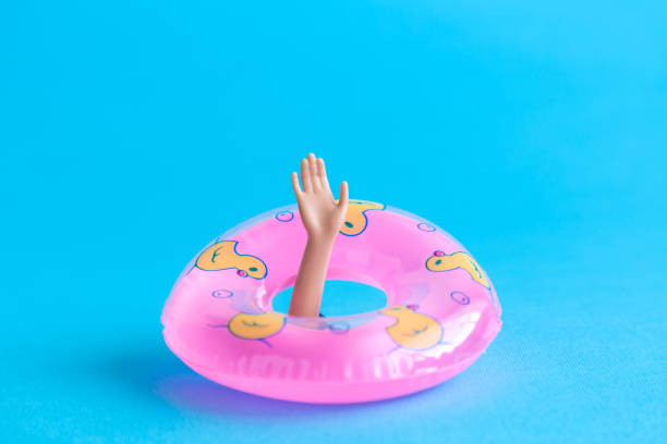 istock Doll hand from the water with inflatable pool float minimalistic abstract. Space for copy. 1051323362