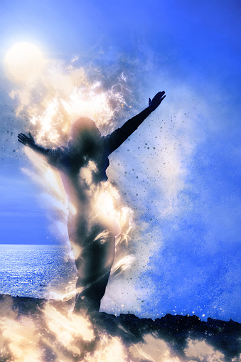 a lone woman raising her arms spiritually on fire facing a powerful wave on the cliffs edge