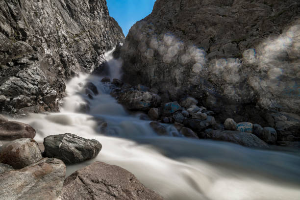 Motion of lake with rock in Xinjiang, China Stream in the mountain. long shutter speed stock pictures, royalty-free photos & images