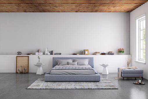 Modern bedroom interior, with bed, night tables, lamps, and many details around. Many books and decoration, wall is rich in texture. Copy space background template render