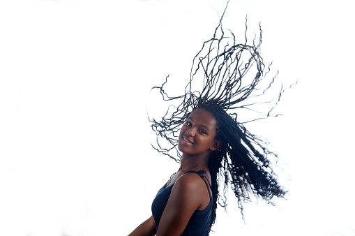 African teen woman dancing on white background
