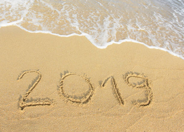 istock New Year, 2019 in beach sand. 1051327940