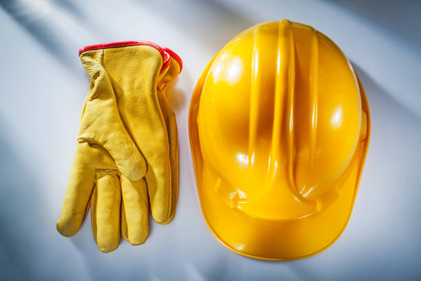 istock Safety gloves building helmet on white background 1051332420