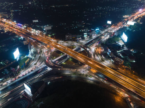 istock Aerial view 4 way stop road or highway road intersection at night for transportation, distribution or traffic background. 1051342596
