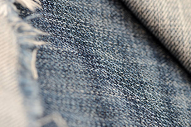 istock Old torn blue jeans texture and background close up 1051345360