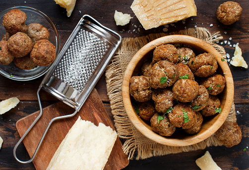 Fresh fried meatballs in a bowl on a wooden table