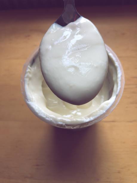 istock Spooning Biteful of Yogurt 1051355328