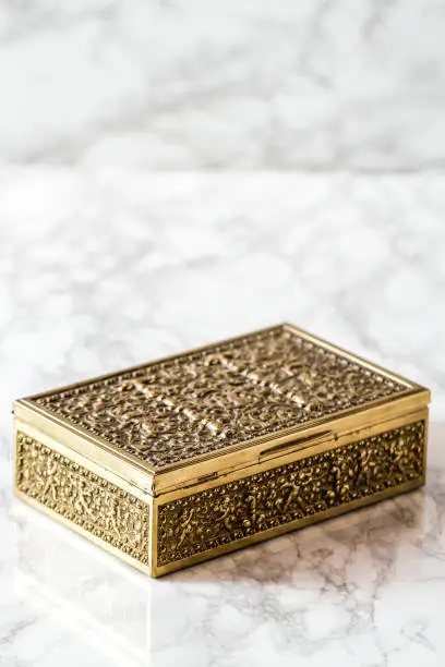 Vintage brass metal decorative box on marble background