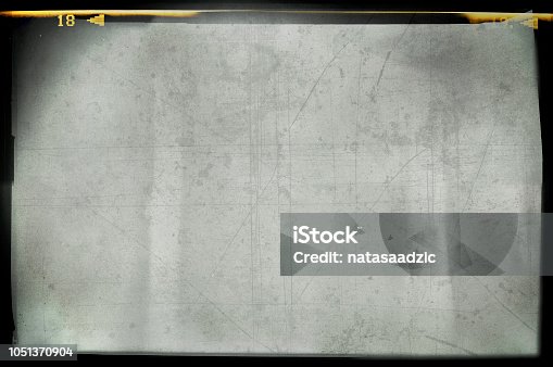 istock Blank grained and scratched film strip texture background 1051370904