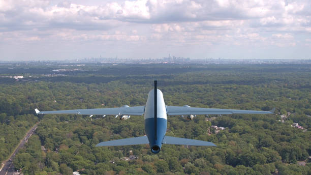 istock AERIAL: Big transatlantic plane flies over the green forest and toward Newark. 1051371880