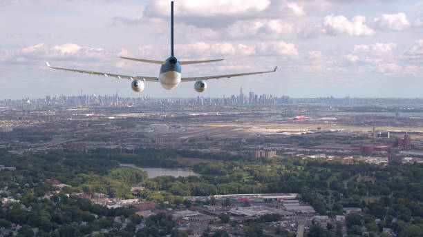 istock AERIAL: Flying behind large aircraft approaching Manhattan in the distance. 1051371896