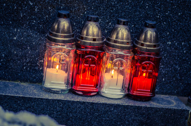 istock burning candles at the cemetery 1051372606