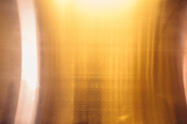 istock Curved shiny glossy copper sheet on the modern art deco style interior wall texture background 1051376946