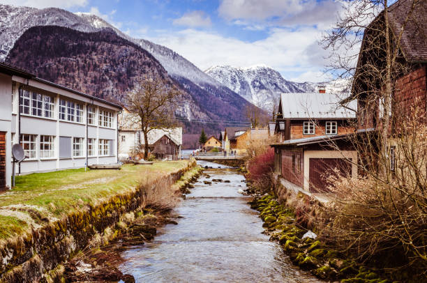 istock Small mountain river in the village in Austria 1051380964