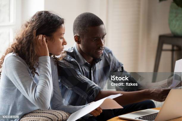 Stressed Black Couple With Bills And Laptop At Home Stock Photo - Download Image Now