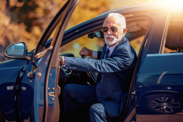 istock Side view of confident senior man driving his car 1051385604