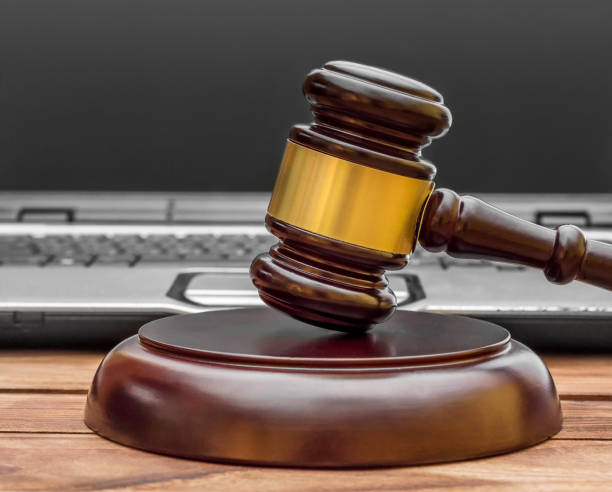istock Judge's gavel with laptop on the table. 1051386234