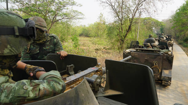 istock Soldiers Riding In Vehicle On Road By Trees 1051391440