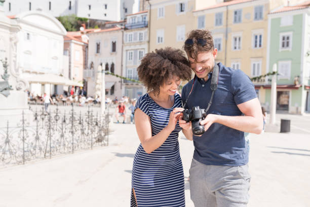 istock Young Couple Looking Photos On Camera 1051395210