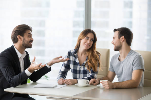 istock Happy couple excited when talking with agent in office 1051395270