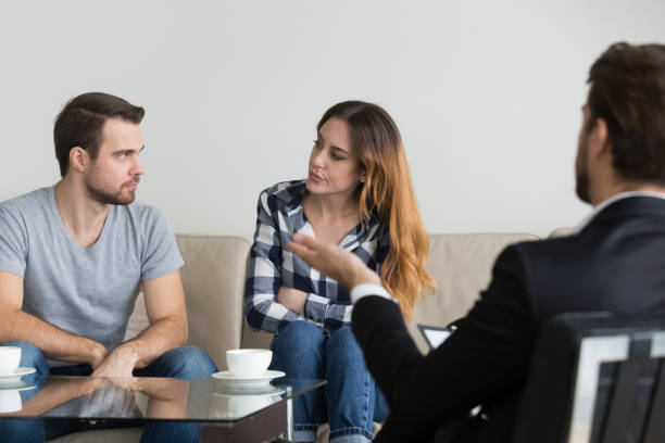 istock Angry couple looking at each other taking therapy session 1051395314