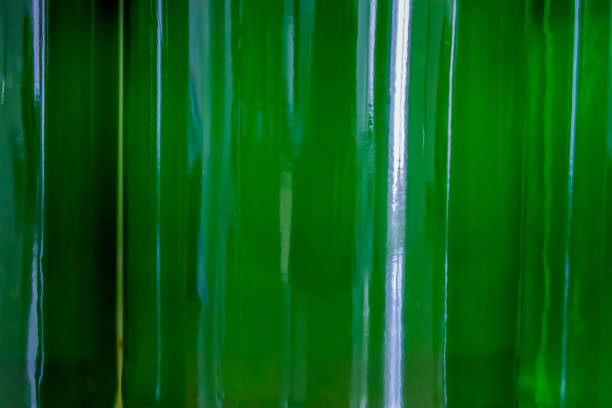 A green pattern / background with back-lit green wine bottles