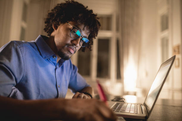 Student writing an essay a night before the exam