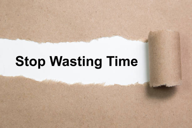 istock Stop Wasting Time text on paper. Word Stop Wasting Time on torn paper. Concept Image. 1051413530