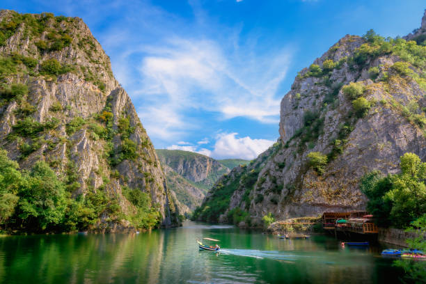 Matka canyon with boat in lake Matka canyon in Macedonia near Skopje, boat on the lake. Visit the beautiful places in the world, experience and learn what travel teaches. north macedonia stock pictures, royalty-free photos & images