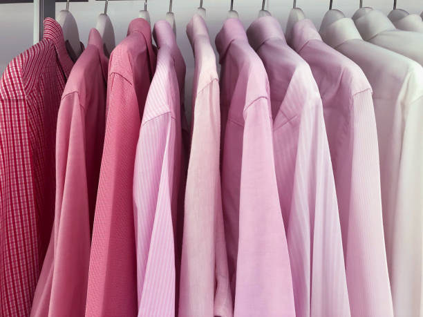 istock Pink men's shirts hanging in closet 1051416858