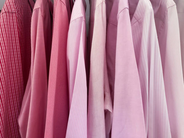 istock Pink men's shirts hanging in closet 1051416866