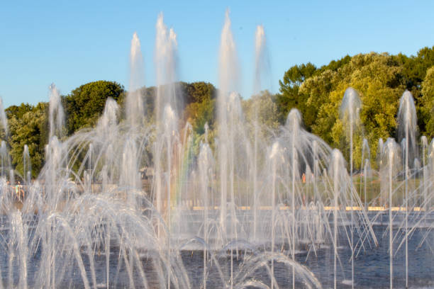 istock Fountain with water spurting up different streams. Multi-colored rainbow in the fountain. 1051417068