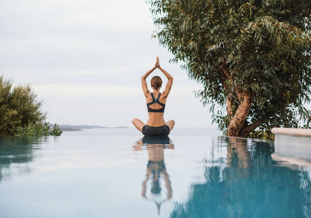 Woman is practicing yoga outdoors. Meditation and harmony concept