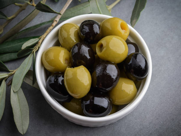istock Olives with olive branch and olive oil, view from above. 1051421406