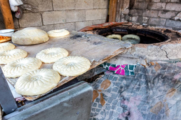istock Uzbek flatbread is preparing to put in the tandyr 1051427720