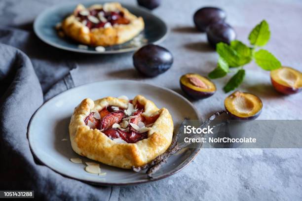 Mini Plum Galettes With Almond Slices Stock Photo - Download Image Now - Plum, Dessert - Sweet Food, Sweet Pie