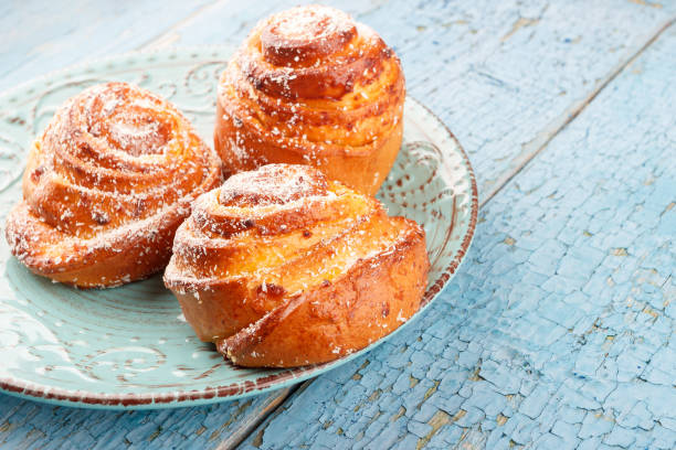 istock Buns on the blue ceramic plate, wooden background 1051431298