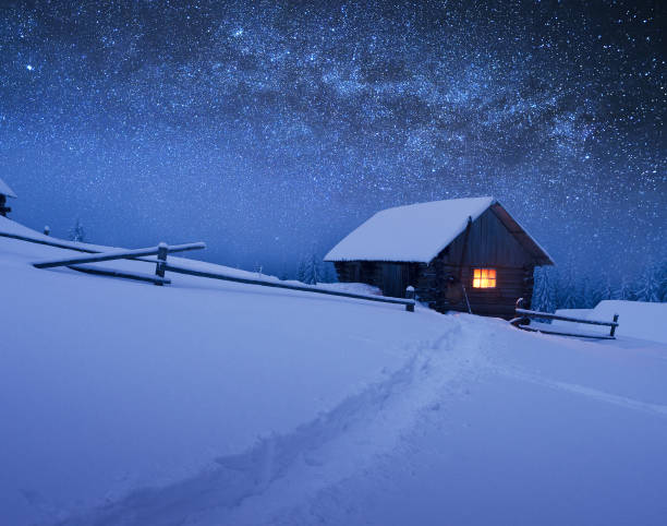 Christmas landscape with starry sky Night with stars. Christmas landscape. Wooden house in the mountain village hut photos stock pictures, royalty-free photos & images