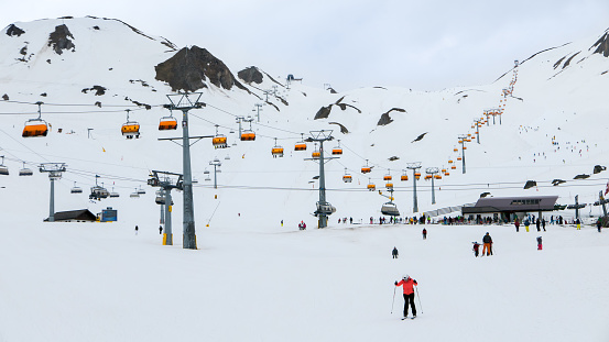 Very long chairlift in popular European ski resort in Austria