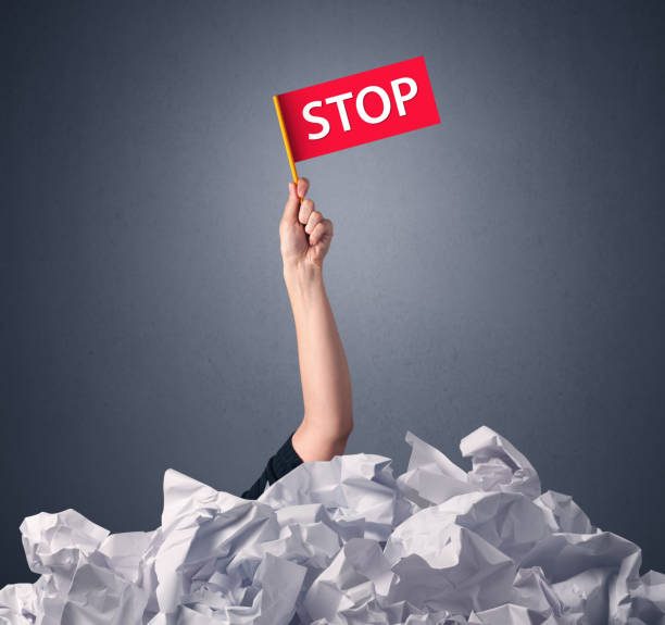 istock Female hand holding stop sign 1051438486