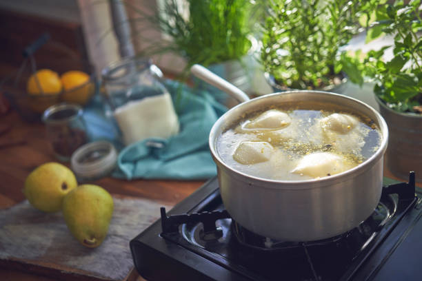 istock Preparing Poached Pears in Vanilla Lemon Syrup glazed with Dark Chocolate 1051443100