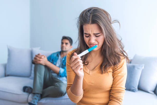 istock Desperate young woman is crying about her unwanted pregnancy 1051446232