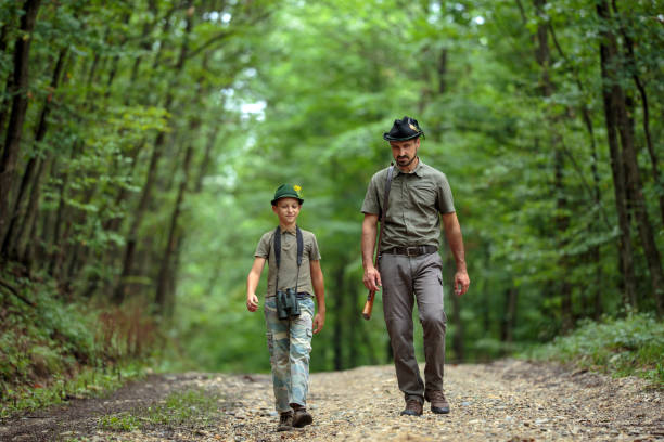 istock Ranger and his son in the woods 1051446454
