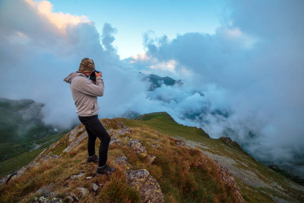 istock Photographer shooting landscape photos 1051446504
